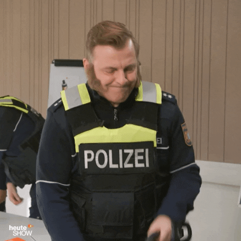Police Man Holding Chain Saw GIF