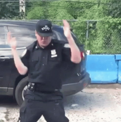 Police Officer Dancing in Front of Car