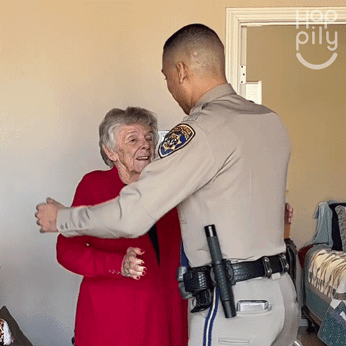 Police Officer Hugging Elderly Woman