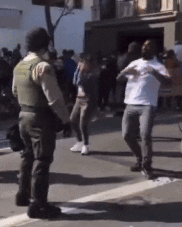 Police Officer In Front Of Crowd GIF