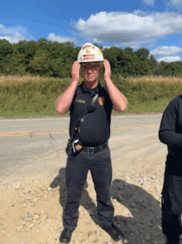 Police Officer In Hard Hat Adjusting Helmet GIF