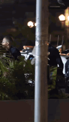Police Officer In Helmet Standing In Front Of Palm Tree GIF