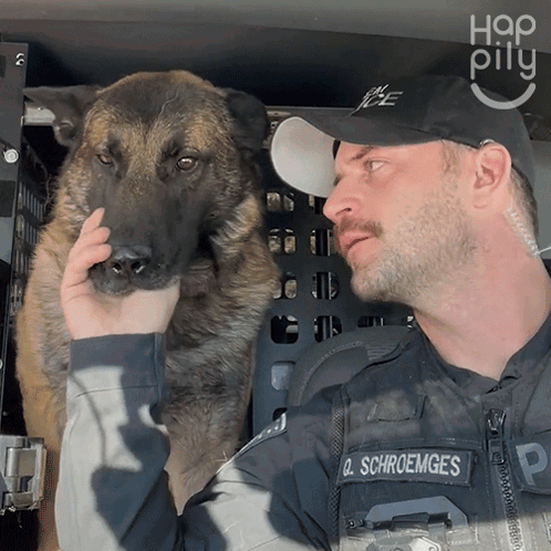 Police Officer Schroemges Holding Dog in Cage