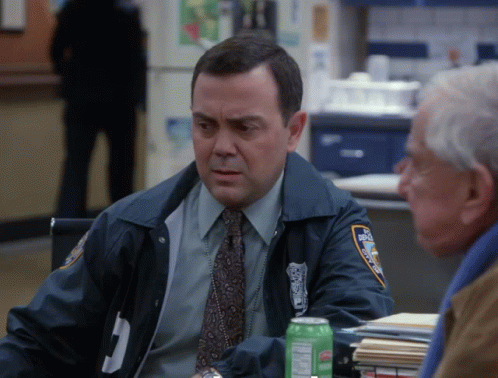 Police Officer Sitting at Table With Gatorade