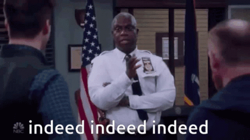 Police Officer Standing in Front of American Flag