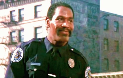 Police Officer Standing in Front of Building