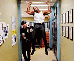 Police Officer Watching Man Do Pull Up