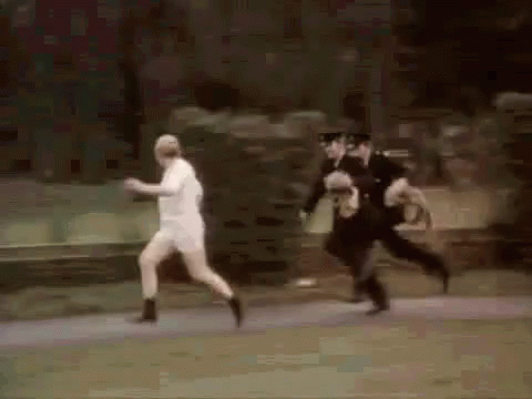 Police Officers Chasing Man In White Shirt GIF