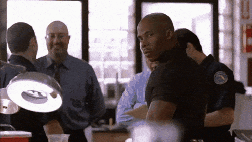 Police Officers Standing Around Table With Light