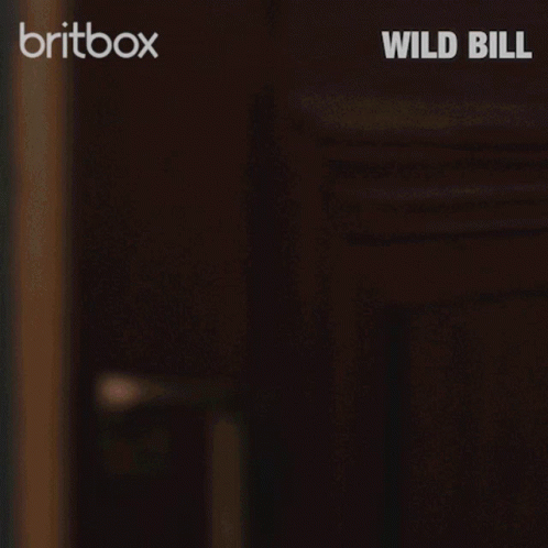 Police Uniform Man Peeking From Behind Door Britbox Wild Bill GIF