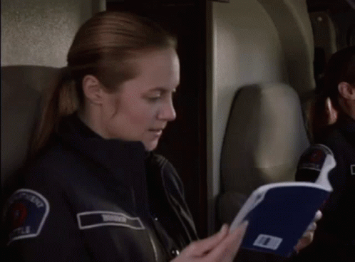 Police Woman on Plane Holding Folder