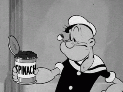 Popeye Is Holding A Can Of Spinach In His Hand . GIF