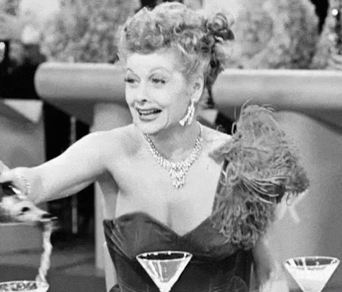 Elegant Lucille Ball Champagne Popping GIF