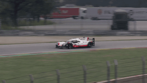 Porsche Race Car Driving on Track