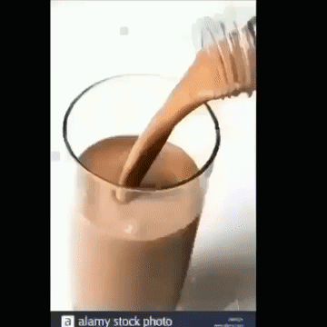 Pouring Chocolate Milk from Bottle into Glass