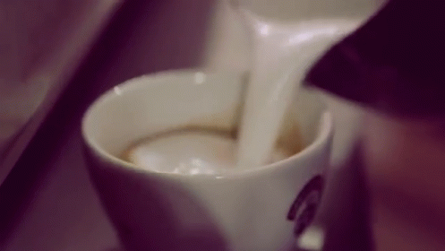 Pouring Milk Into Cup of Cappuccino