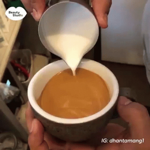 Pouring Milk Into Cup of Coffee