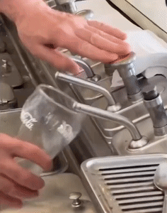 Pouring Water Into Coca Cola Glass