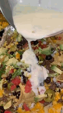 Pouring White Sauce On Nacho GIF