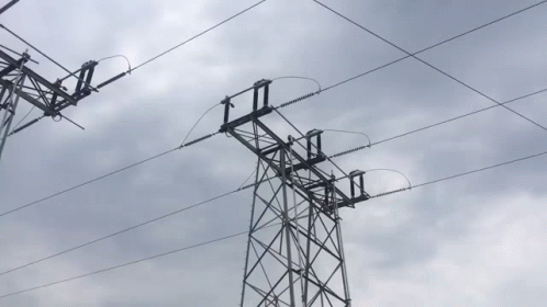 Power Lines Against Cloudy Sky With Tower GIF