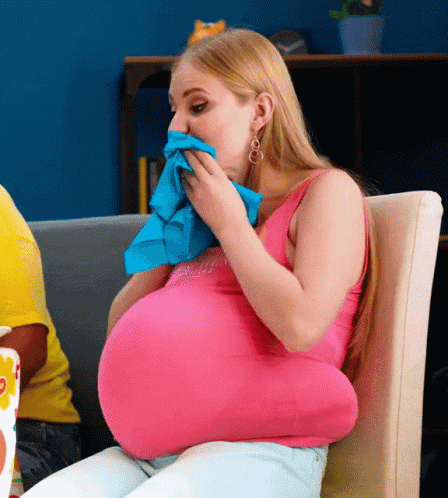 Pregnant Woman Blowing Nose With Blue Cloth