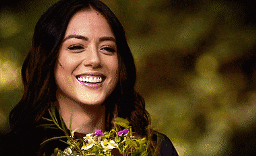 Pretty Chloe Bennet Holding Flowers Smiling GIF