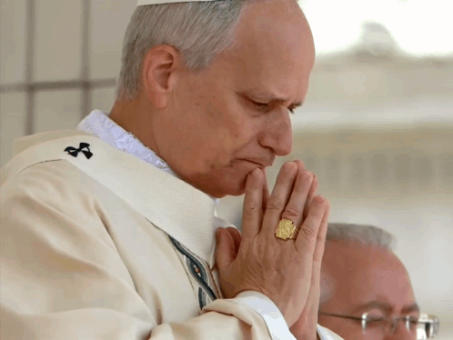Priest Praying with Gold Ring