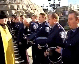 Priest Sprays Holy Water To Officers GIF