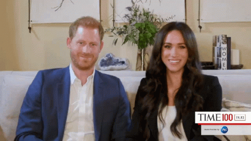 Prince Harry and Meghan Markle Sitting on Couch Smiling