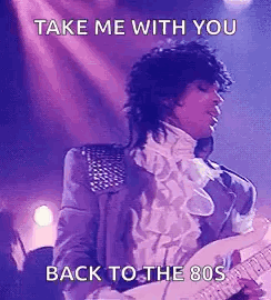 Prince Is Playing A Guitar On Stage And Singing . GIF