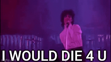 Prince Is Standing In Front Of A Microphone On A Stage And Singing . GIF
