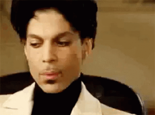Prince Is Wearing A White Suit And Black Turtleneck . GIF