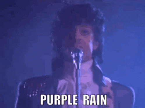 Prince Singing Into A Microphone With The Words Purple Rain Below Him GIF