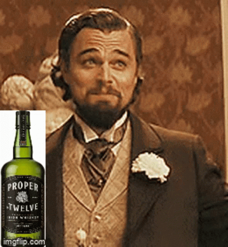 Proper Twelve Whiskey Bottle Next to Man in Suit