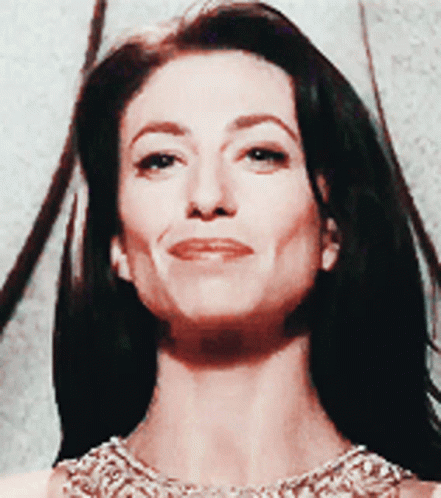Proud Claudia Black Demure Smile GIF