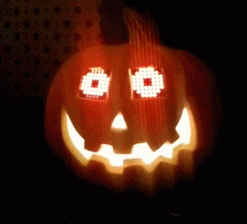 Pumpkin with Pixelated Face Lit in Dark