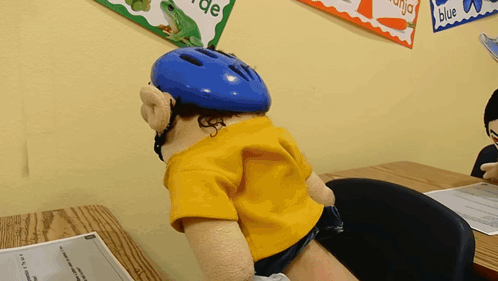 Puppet in Helmet at Desk