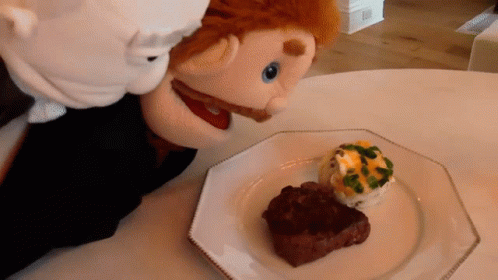 Puppet Looking At Plate Of Steak GIF