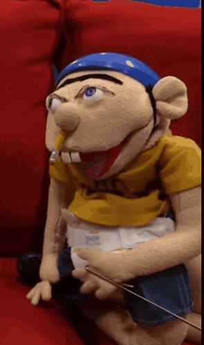 Puppet With Diaper Sitting On Couch GIF