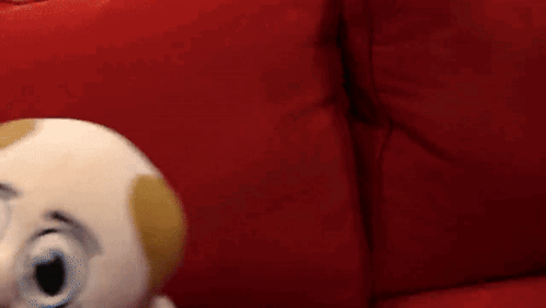 Puppet With Mustache On Red Couch GIF