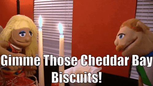 Puppets At Table Say Gimme Cheddar Bay Biscuits GIF