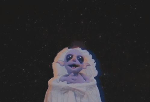 Purple Cartoon Character Sitting in Crib