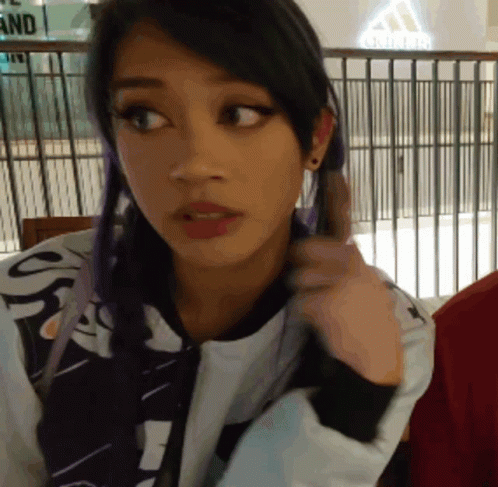 Purple Hair Woman Looking at Camera by Adidas Sign