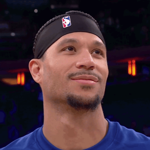 Purple Lakers Player Holding Candy Canes at Christmas Tree