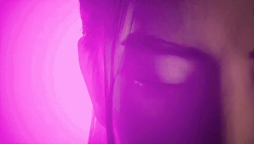 Purple-Lit Woman Face Close-Up
