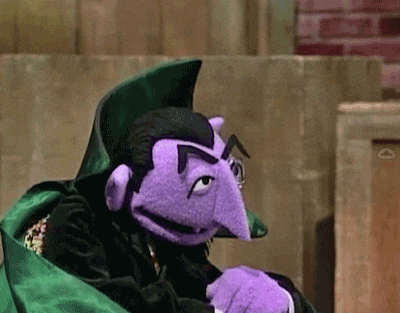 Purple Puppet in Green Cape with Purple Nose and Mustache