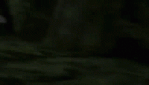 Purple Robot With Sword And Shield Walking In Dark GIF