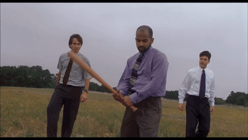 Purple Shirt Man Holding Bat with Two Men