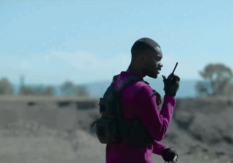 Purple Shirt Man Talking on Walkie Talkie Desert