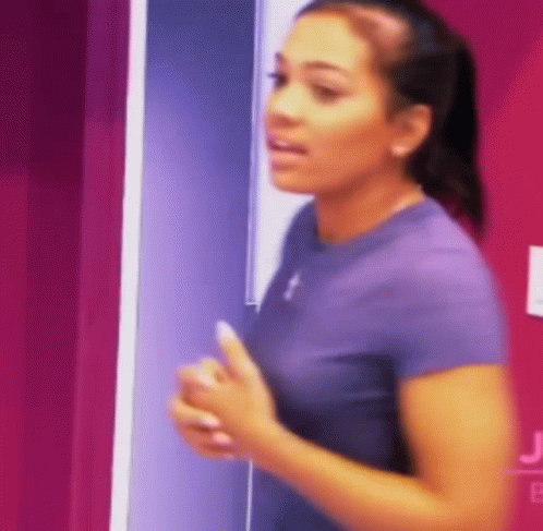 Purple Shirt Woman at Pink Wall with J